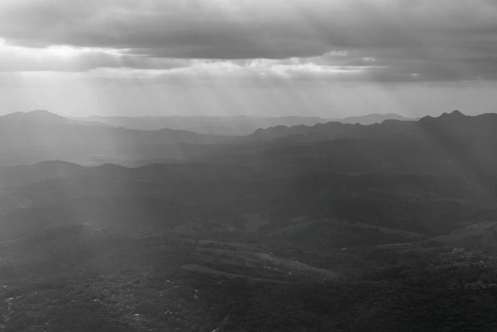 Sun rays over a dark mountain ridge