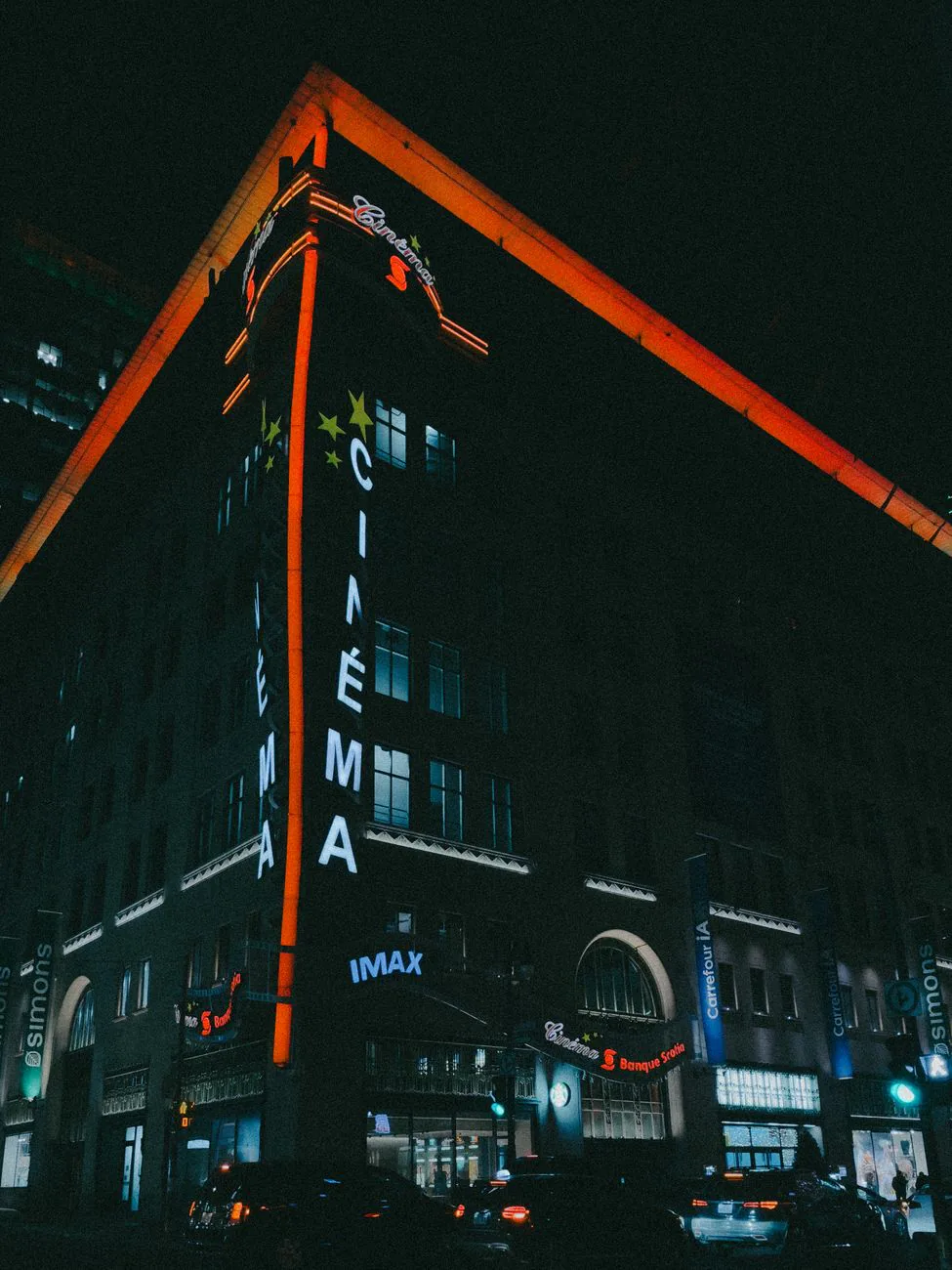 Neon-lit cinema facade at night