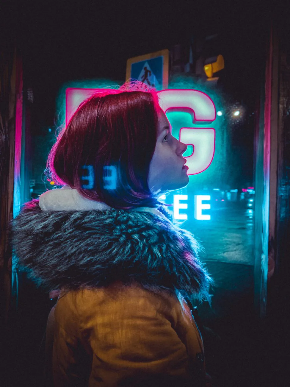 Woman framed by a glowing neon window
