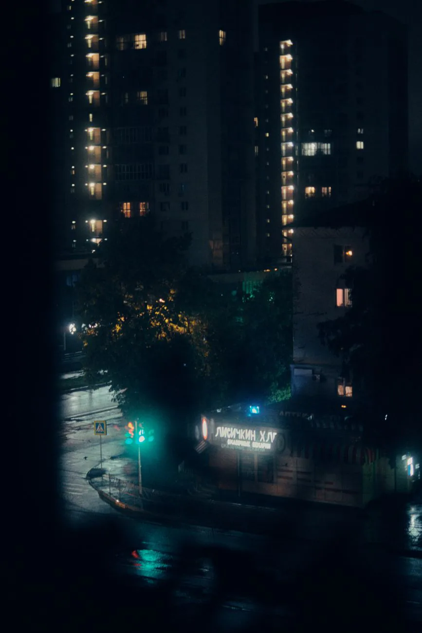 Rain-soaked city street at night